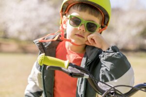 boy with helmet riding bicycle